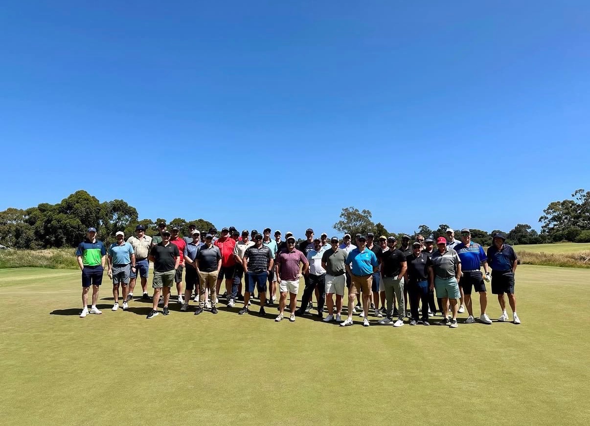 Full field of players on the green at a 4QTR golf day